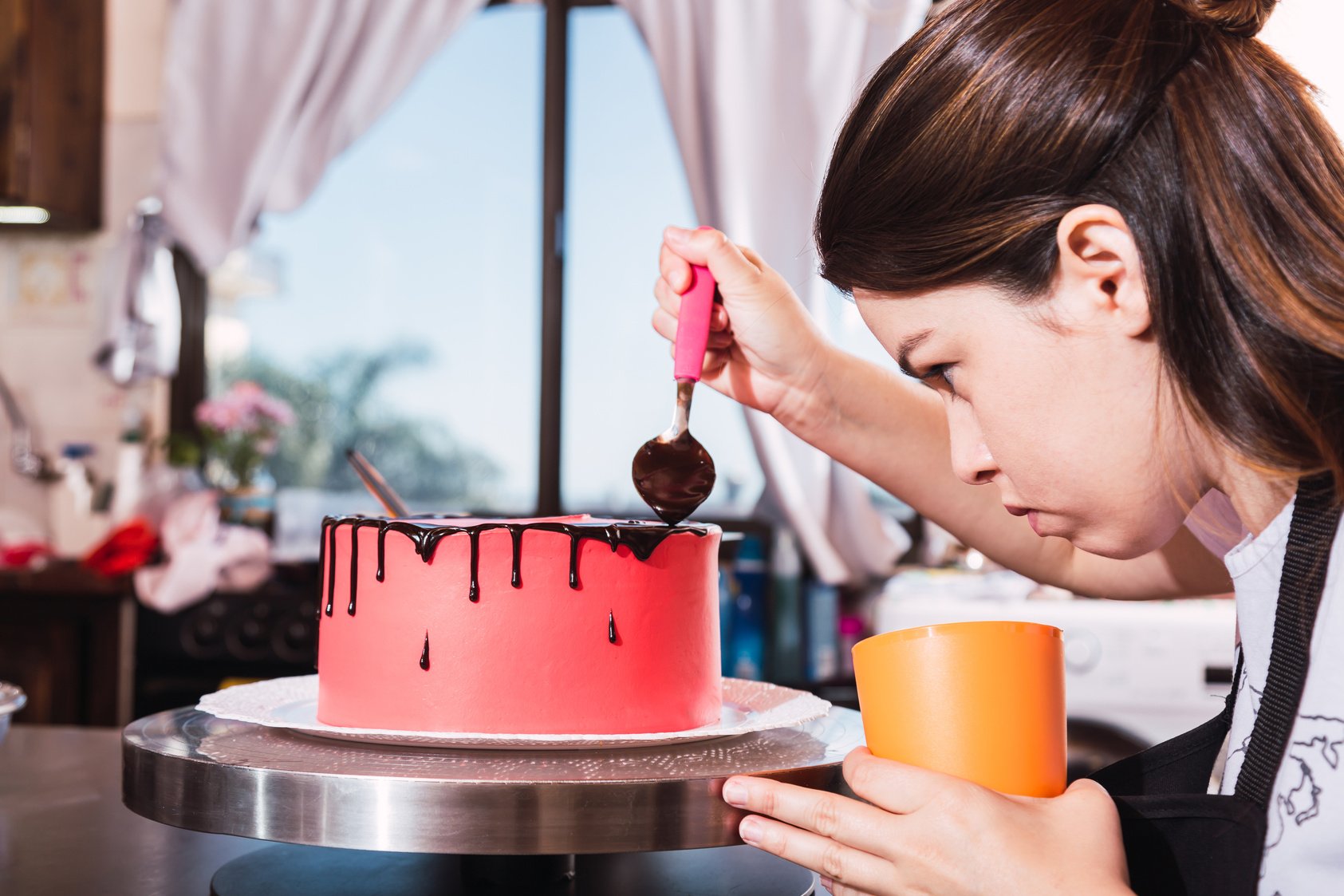 Confectioner Decorating Cake with Chocolate.