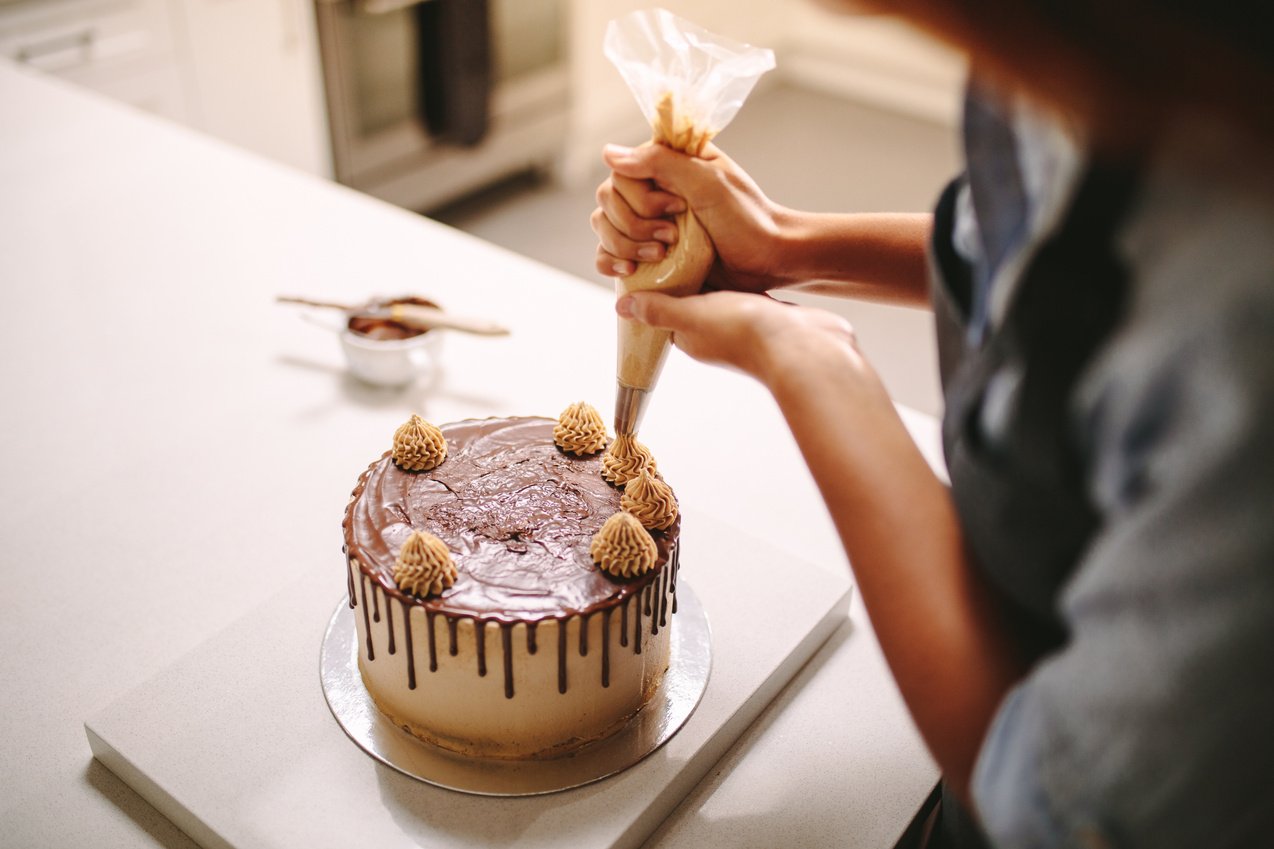 Chef Decorating Cake with Cream