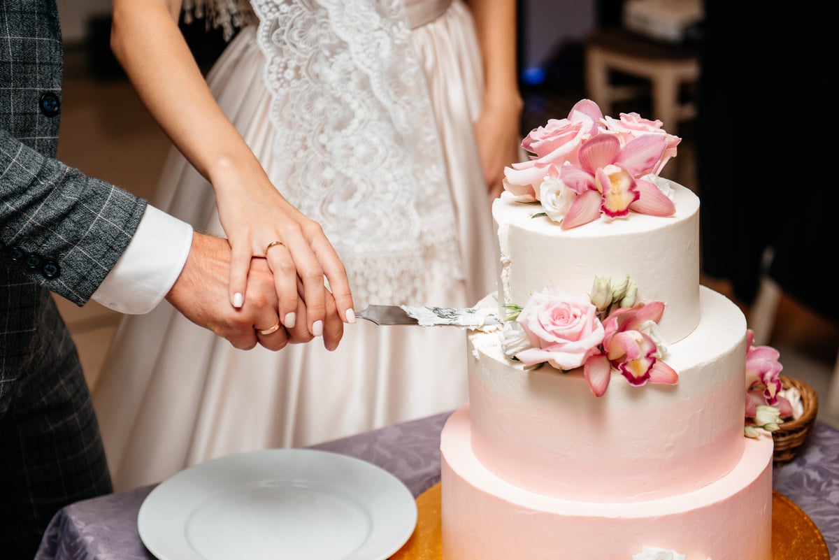 Newlyweds cutting wedding cake